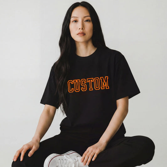 Woman wearing black custom 3D outline embroidery t-shirt in orange — Embroidist