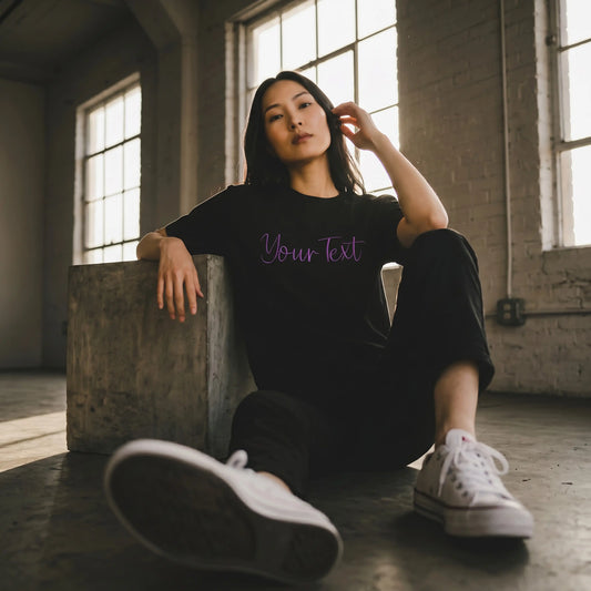 Model wearing custom embroidery t-shirt with violet 3D puff script detail