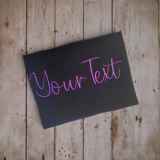 Custom embroidery t-shirt design preview – 'Your Text' in 3D puff purple script on black fabric