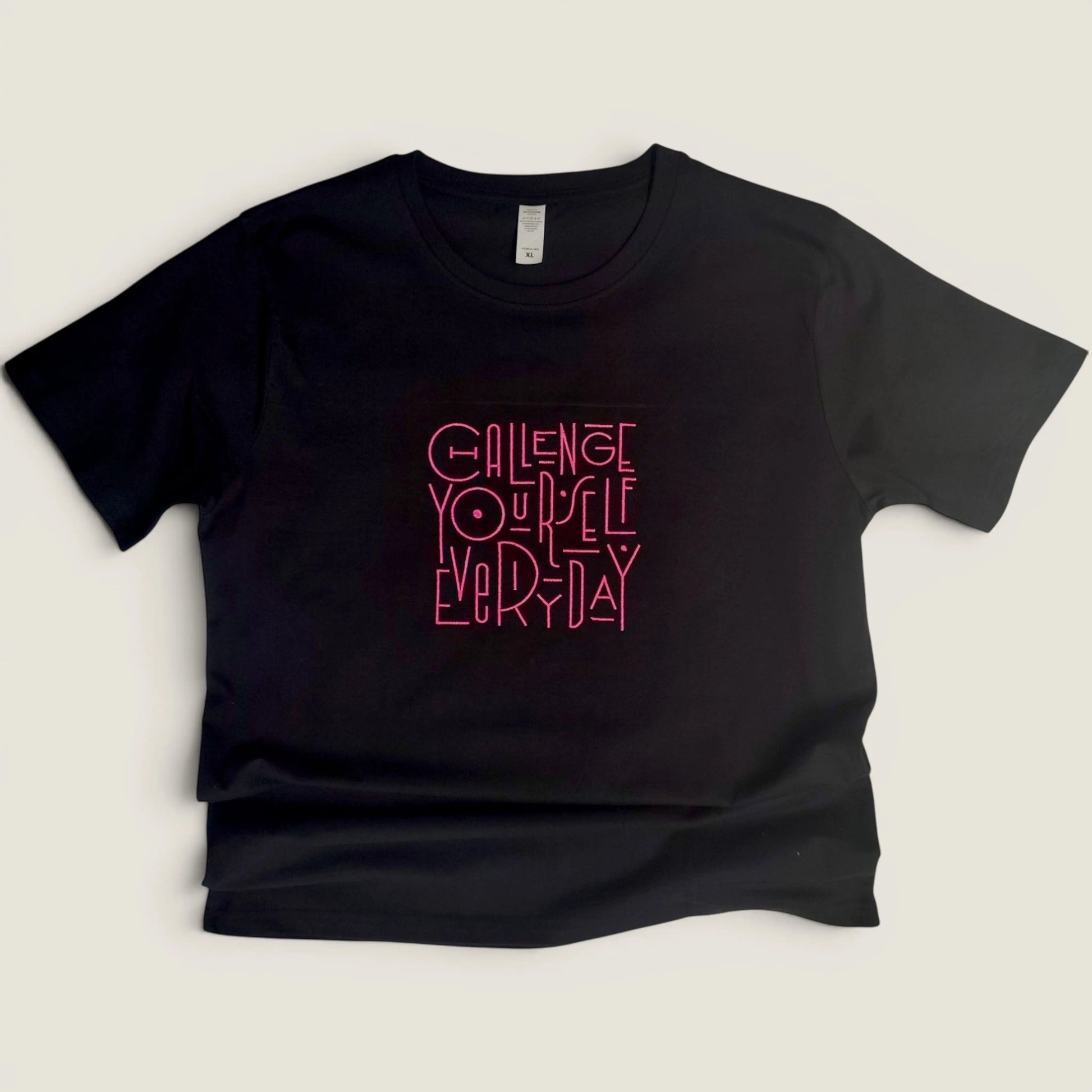 full view of black embroidered t-shirt showing Challenge Yourself Everyday design
