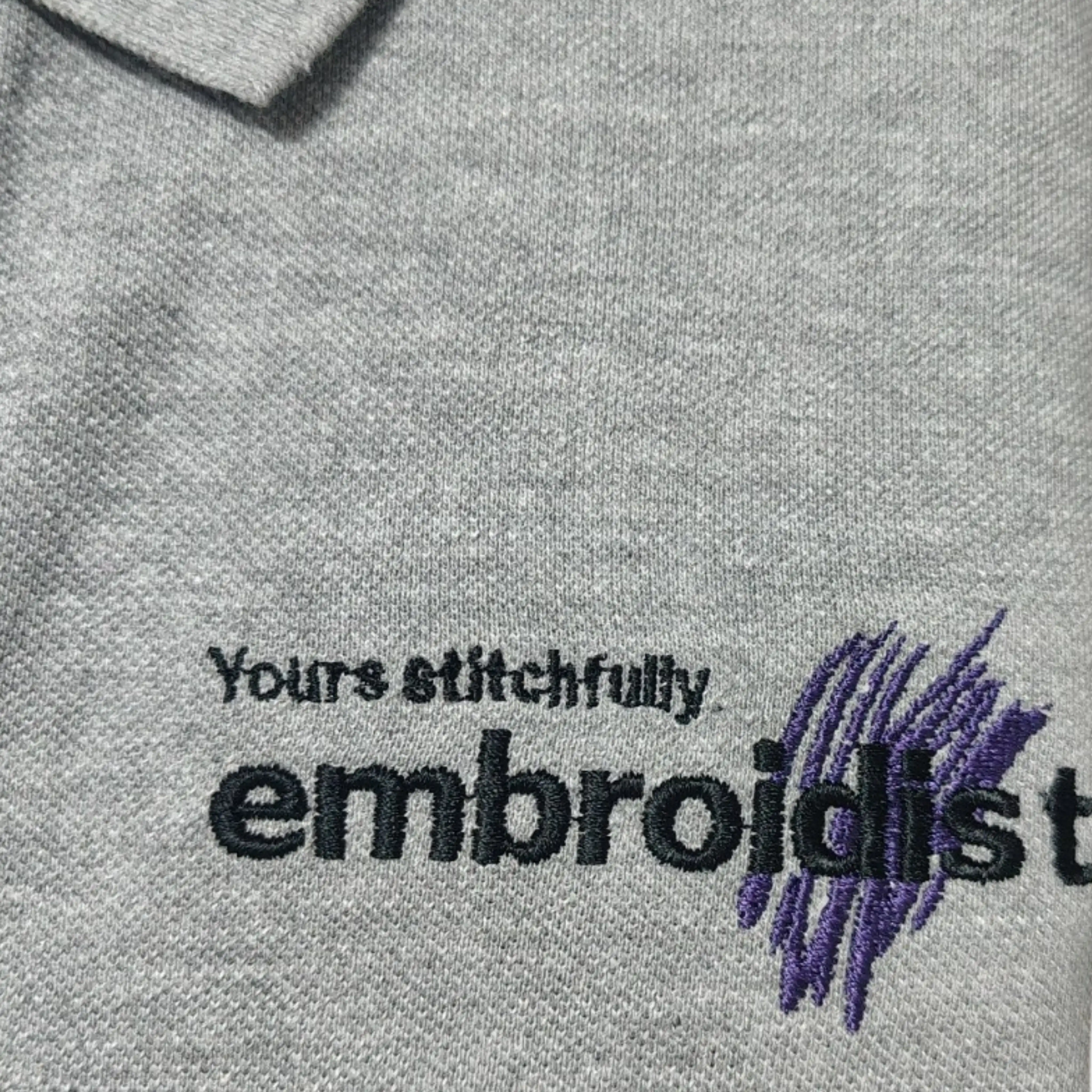 close-up of Embroidist brand embroidery on grey t-shirt