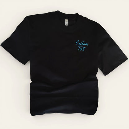 Black oversized t-shirt with left chest custom text embroidery — made to order by Embroidist