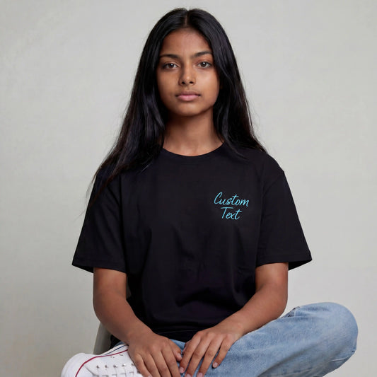 Woman wearing black t-shirt with small left chest custom text embroidery — Embroidist personalised tee