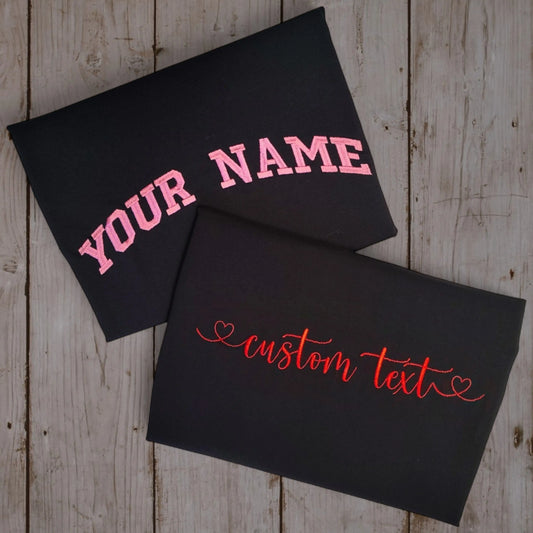 Custom embroidered black t-shirt with pink varsity YOUR NAME and cursive custom text — Embroidist