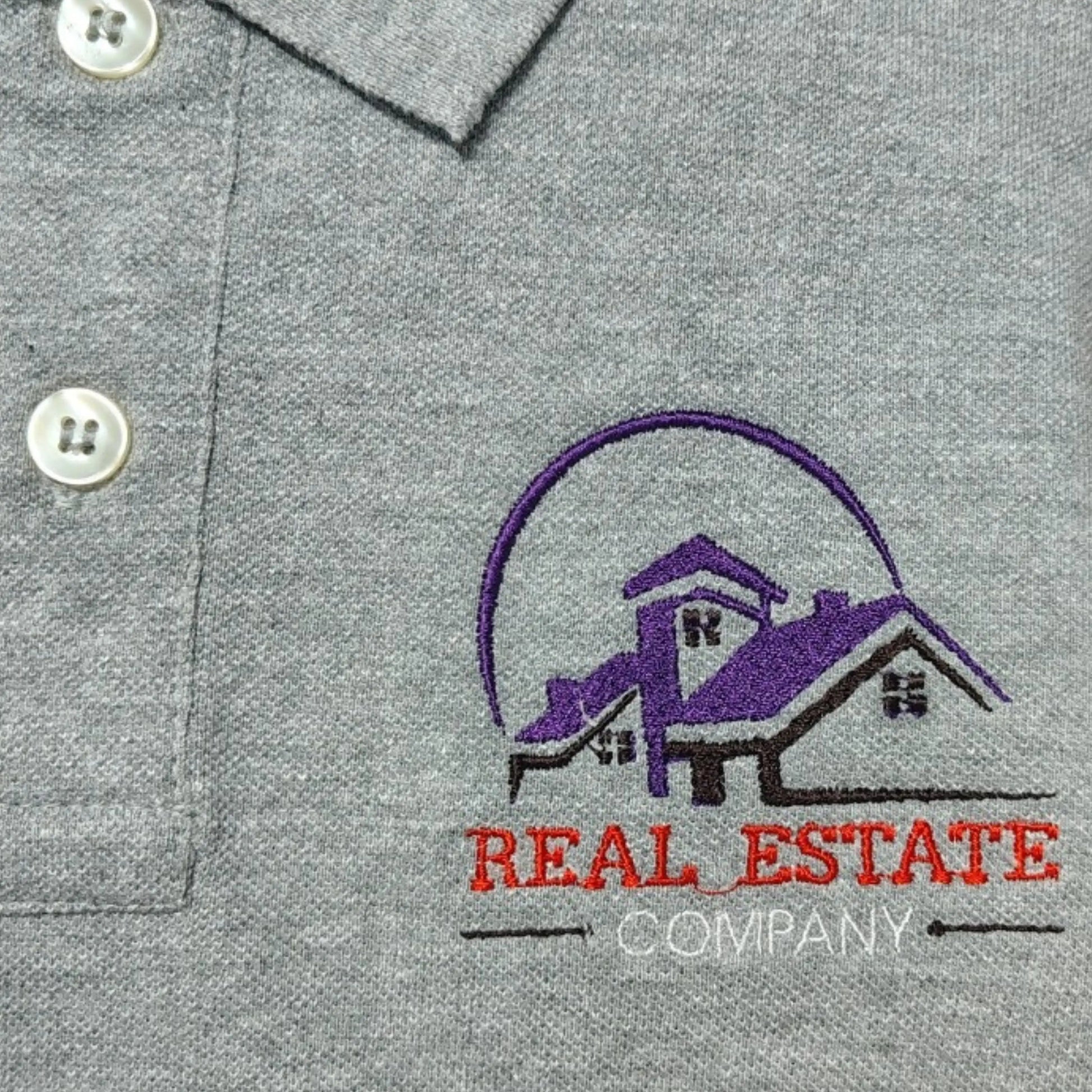 Custom real estate company logo embroidered on grey polo shirt