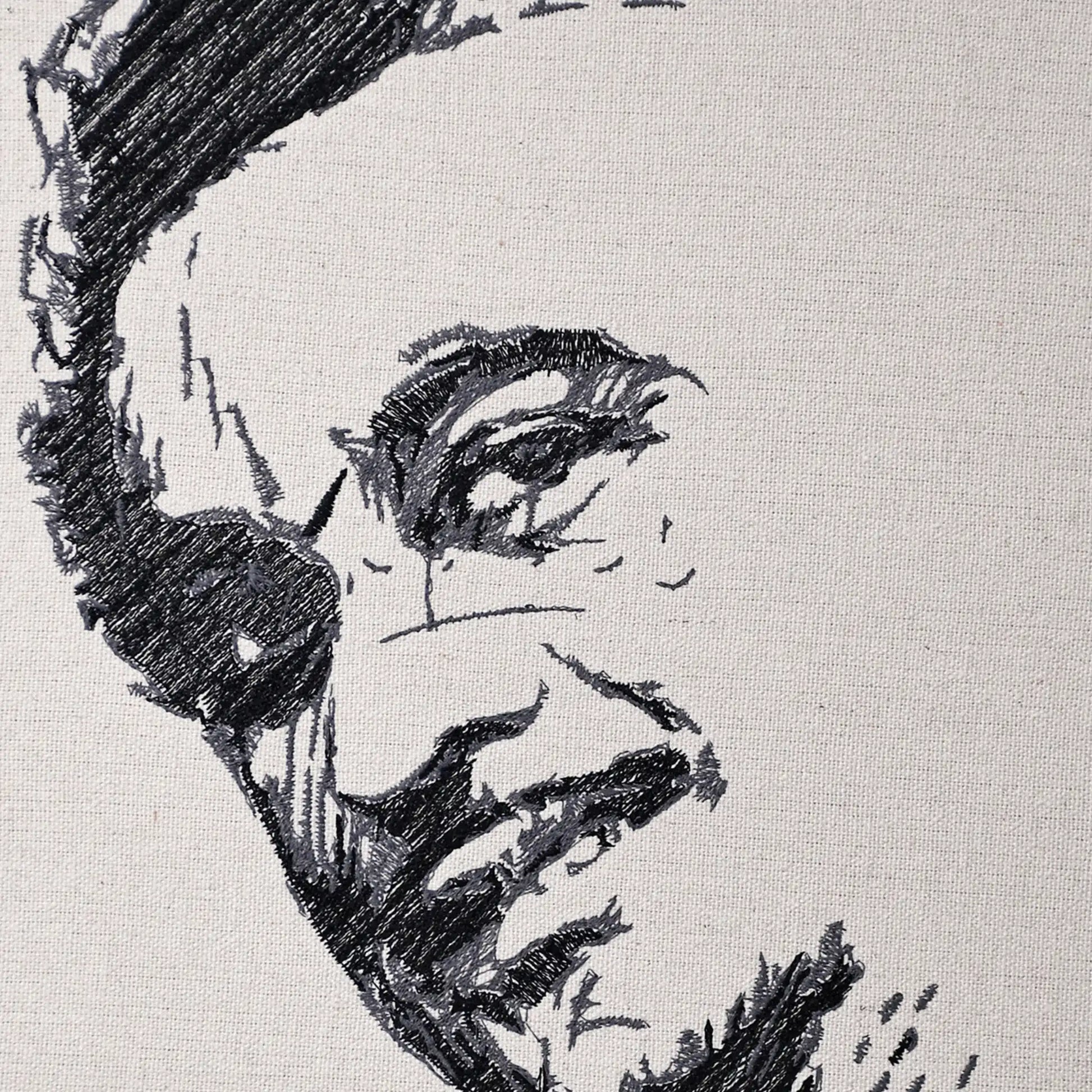 Close up of Kishore Kumar thread embroidery portrait detail — Bollywood wall art by Embroidist