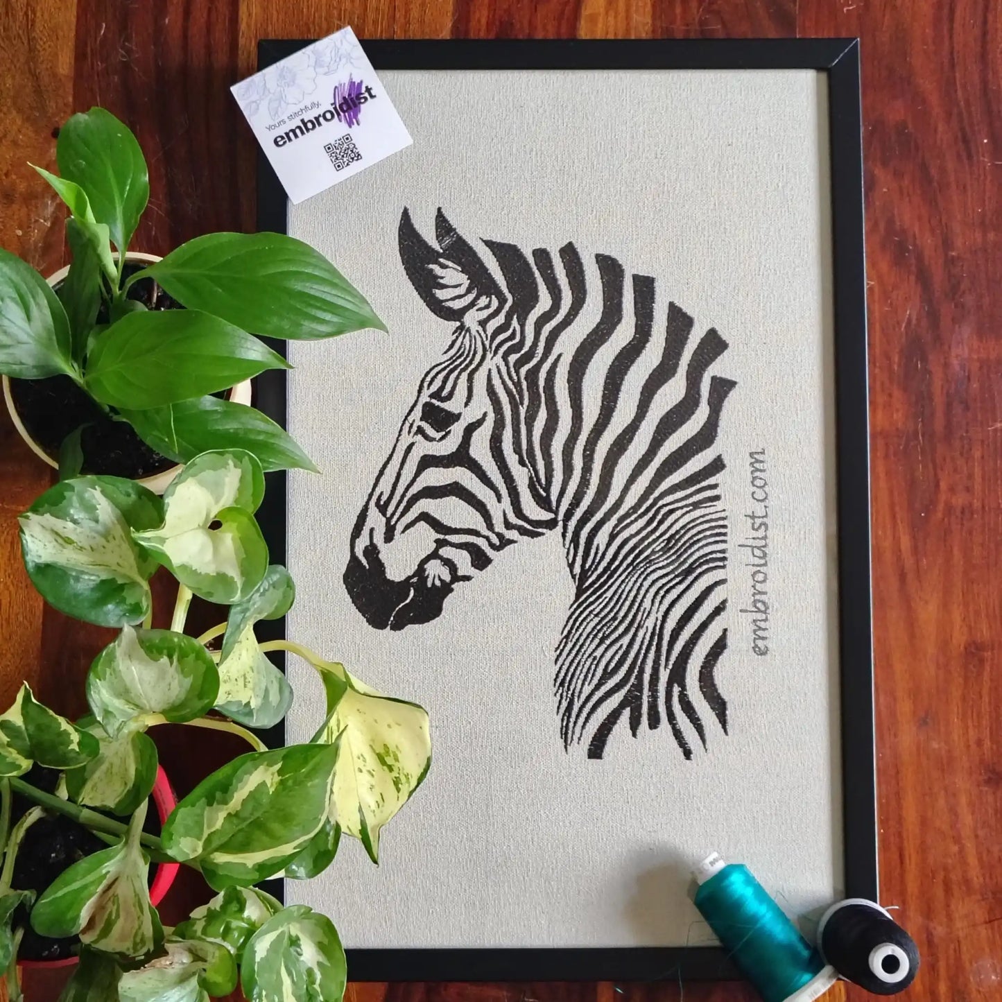 Zebra embroidered wall art lifestyle image — framed art in home setting by Embroidist