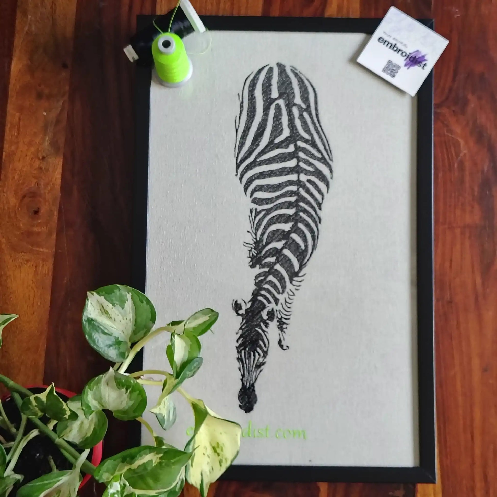 Zebra eagle view embroidered wall art lifestyle image — framed art in home setting by Embroidist