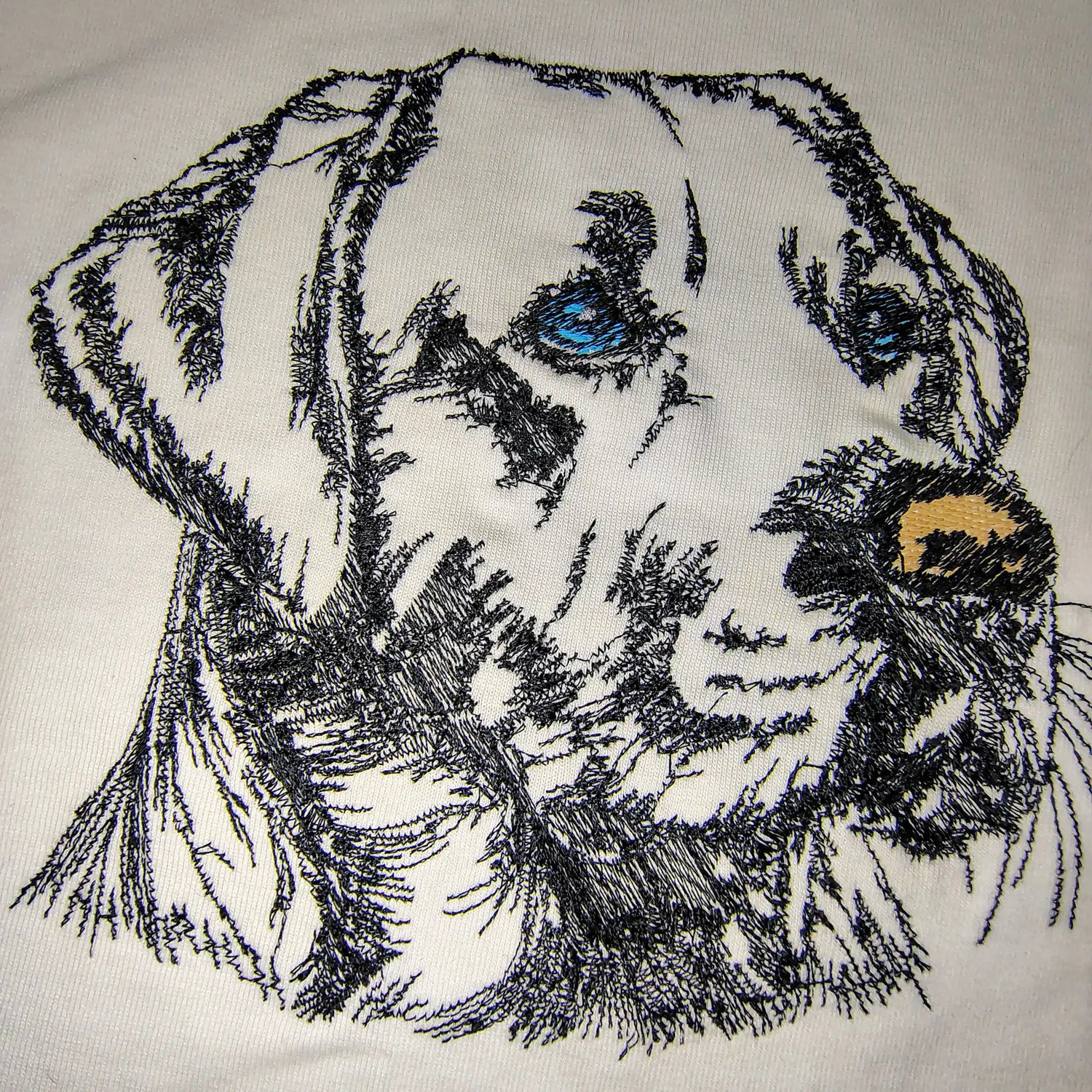 Close-up of Labrador dog face machine embroidery on white t-shirt — custom pet portrait by Embroidist
