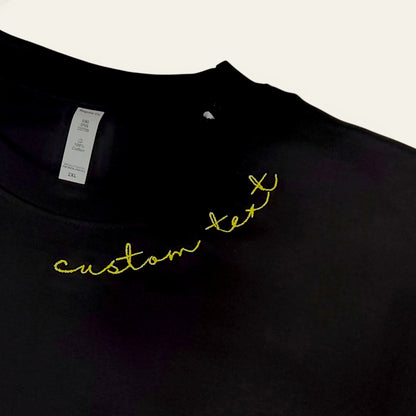 Black bio-washed tee with yellow thread neckline embroidery — made to order