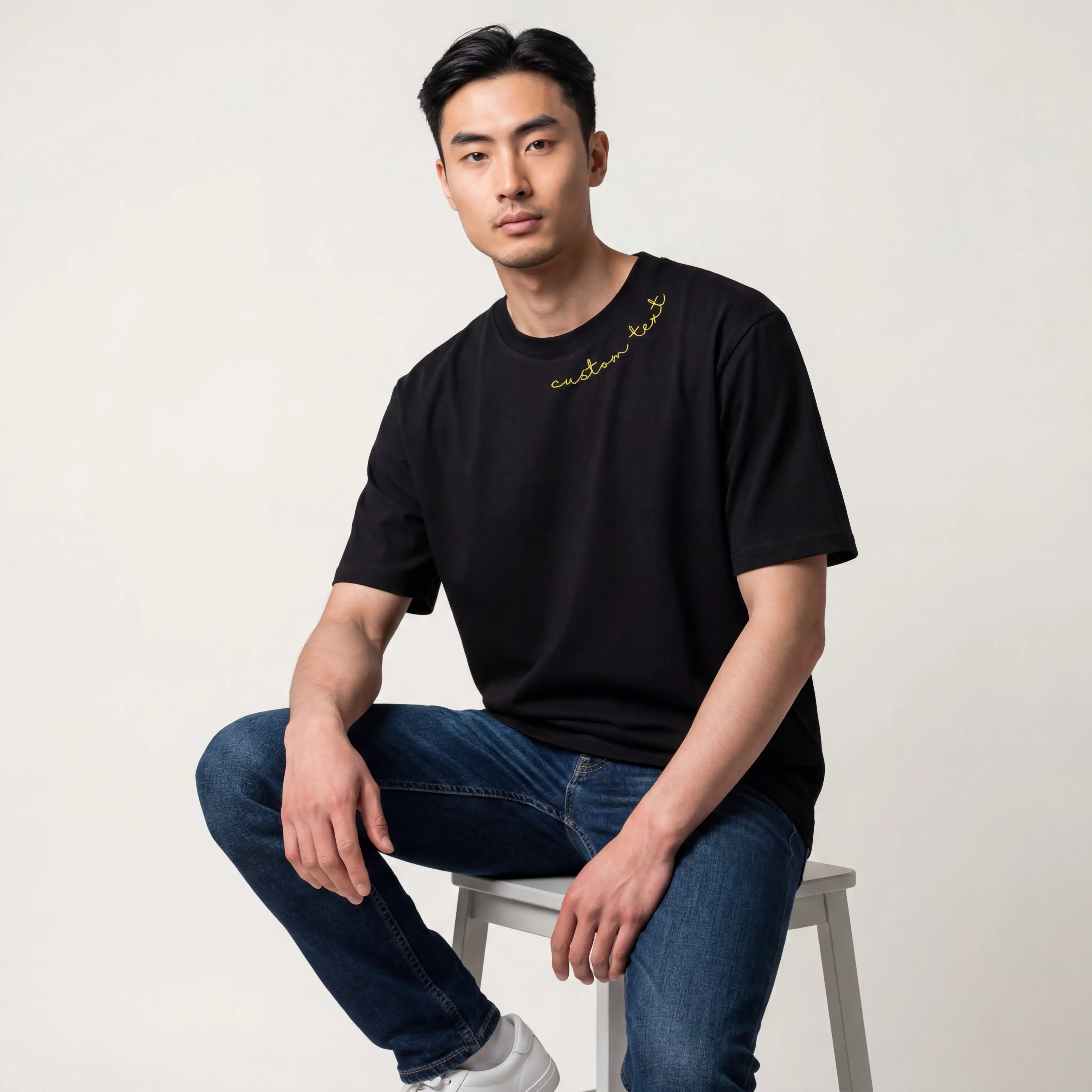 Man wearing black custom name embroidered t-shirt — Embroidist neckline tee