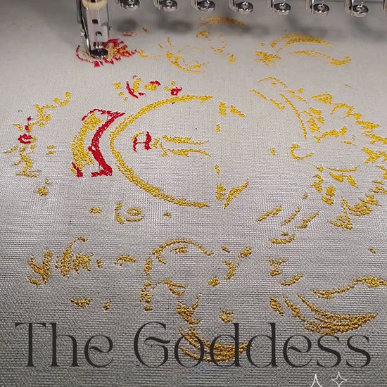 Durga Maa face with flaming crown and floral adornments in gold orange and black multicolour thread on natural linen, 60,329 stitches, framed embroidered wall art handcrafted in India by Embroidist