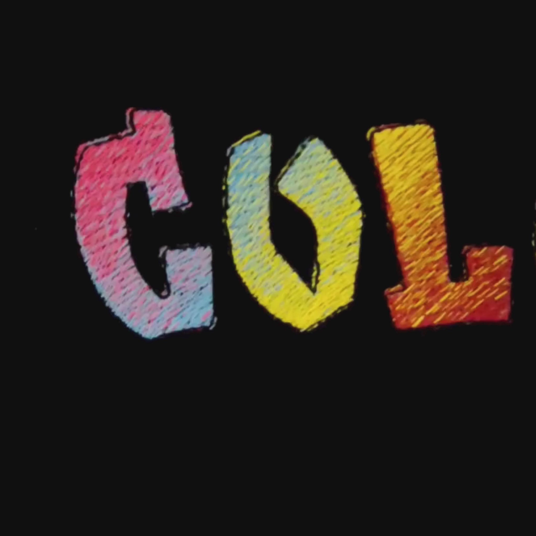 Close-up video of COLORFUL rainbow embroidery detail — multicolour satin stitch lettering on black fabric, by Embroidist.