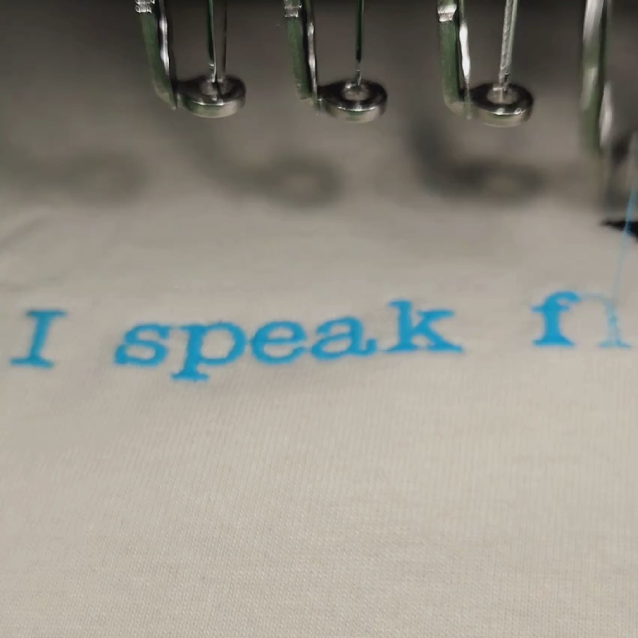German Shepherd embroidery t-shirt — machine embroidered GSD illustration with ice blue "I speak fluent German Shepherd" text on cream oversized tee, custom made in India by Embroidist