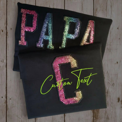 Custom sequin appliqué alphabet tee — PAPA in rainbow sequins and C in pink sequins with lime green script — made to order by Embroidist