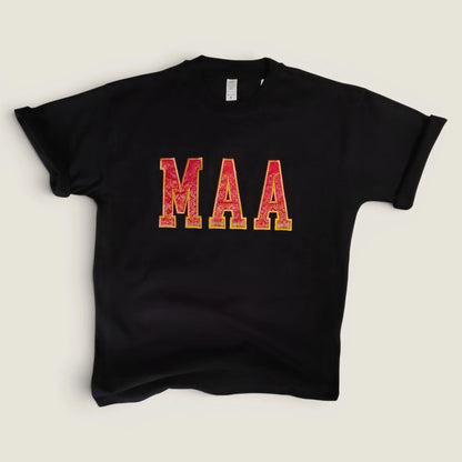 Flat lay of custom Zari embroidery t-shirt with MAA in pink and gold letters | Embroidist